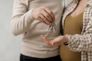 Pregnant couple with house keys